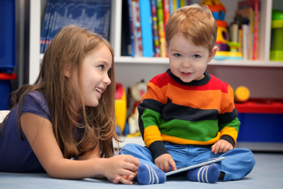 Girl and little brother with digital tablet computer