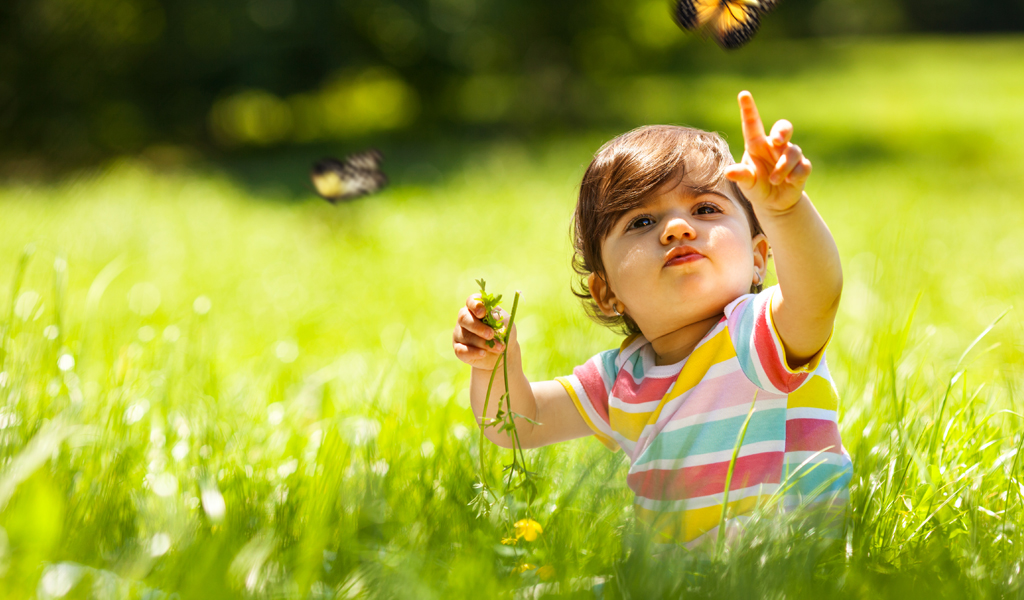 Child in field with butterfly