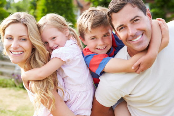 Portrait Of Happy Family In Garden