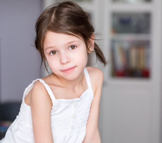 Portrait of smiling adorable preschooler girl at home