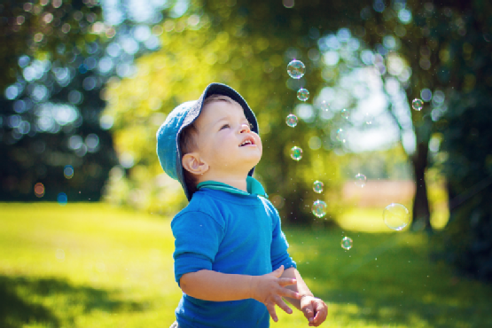 Chid looking at soap bubbles