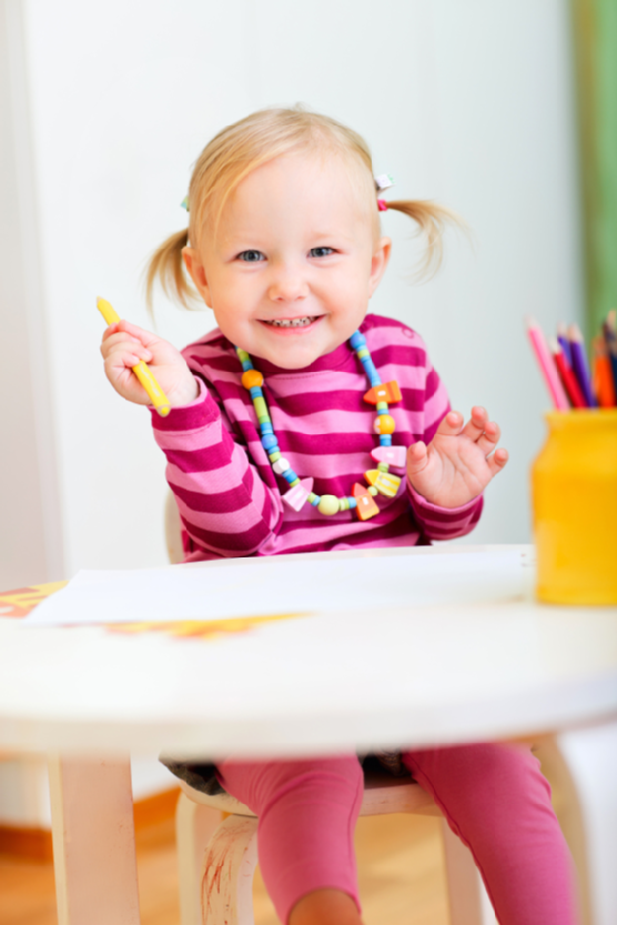 Toddler girl drawing with pencils