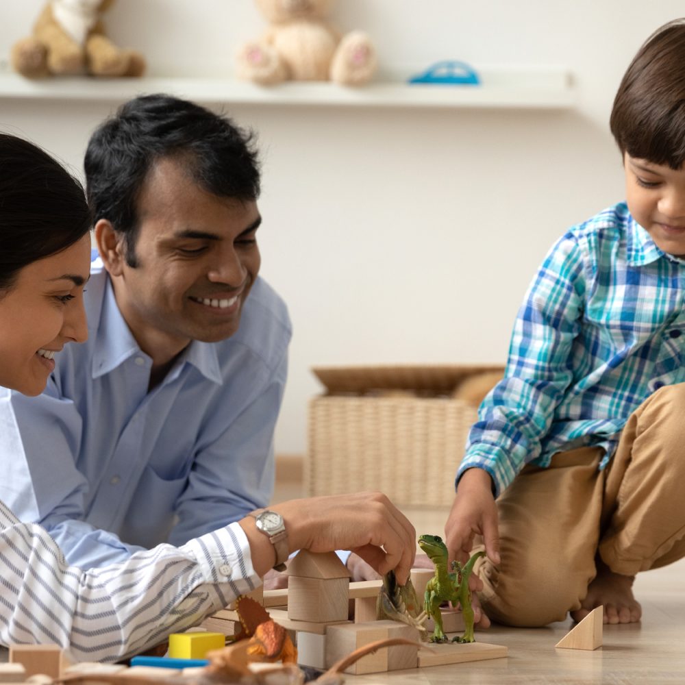 child playing with parents on the floor