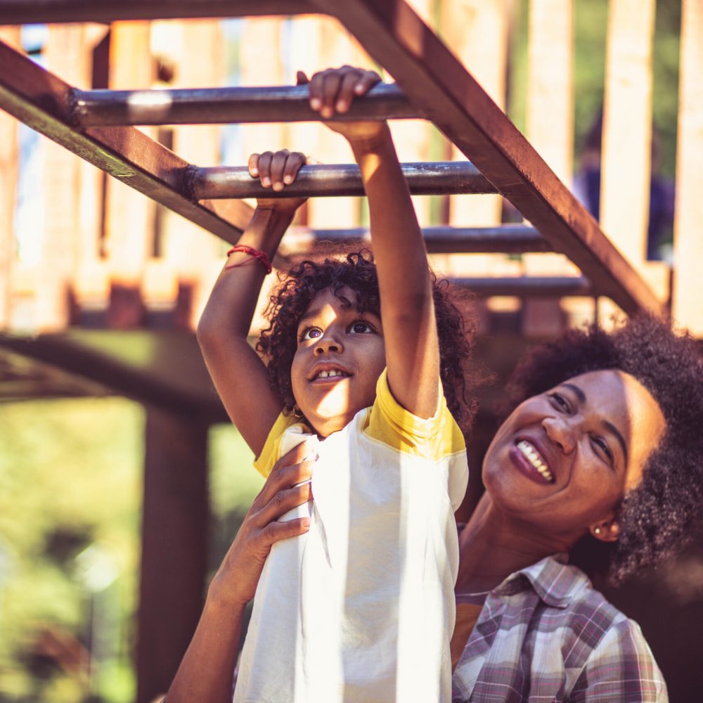 Mother and daughter playing on playground.