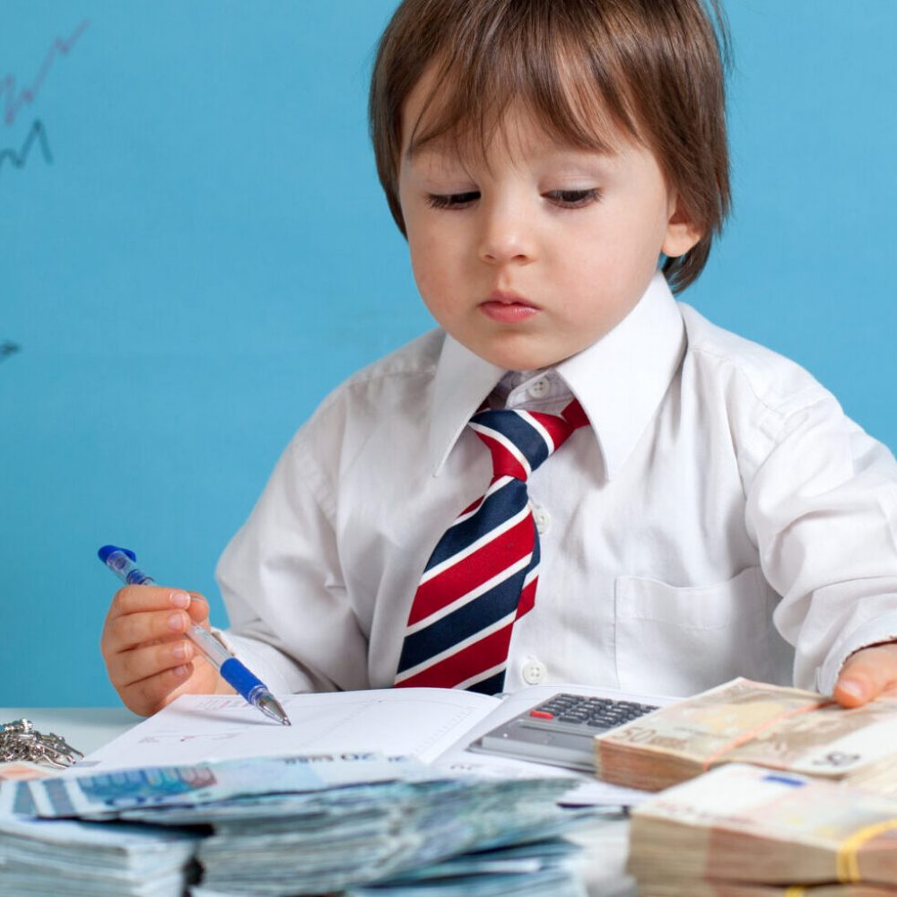 Young boy, counting money and taking notes