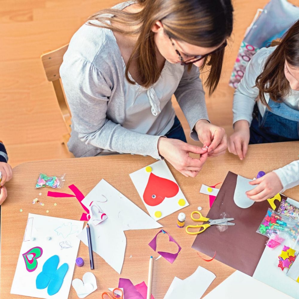 Preschool teacher with kids having creative activities Teacher with Kids - Creative Arts Class.